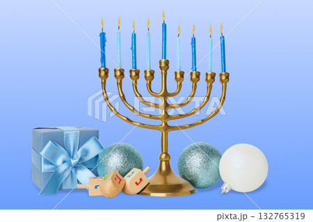 Gold menorah with blue candles alongside gift box and ornaments 132765319