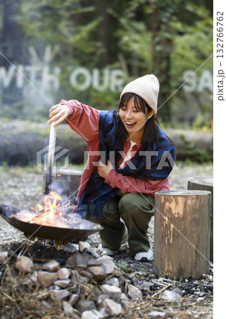 キャンプ場で焚き火をする女性 キャンプ場で焚き火をする女性 132766762