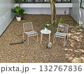 white metal chairs in the garden with rock ground 132767836