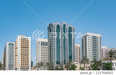 New modern high-rise residential buildings under blue sky in city. Modern apartments with balconies New modern high-rise residential buildings under blue sky in city. Modern apartments with balconies 132768082