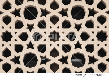 Sandstone decoration pattern jali background. Carved sandstone window in jali pattern Sandstone decoration pattern jali background. Carved sandstone window in jali pattern 132768102
