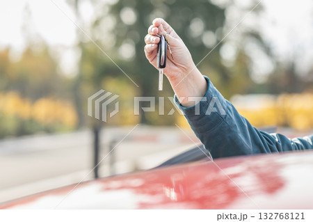 Woman's hand holding car keys. Close up. Female hand holds a car key. Woman's hand holding car keys. Close up. Female hand holds a car key. 132768121