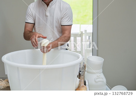 Crafting Fresh Mozzarella A Cheesemaker s Skillful Hands Shaping Curd into Delicious Cheese 132768729