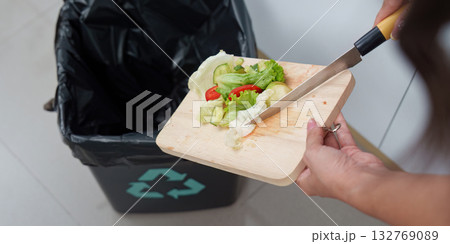 Eco-Friendly Practices: Woman Disposing of Vegetable Scraps Responsibly 132769089