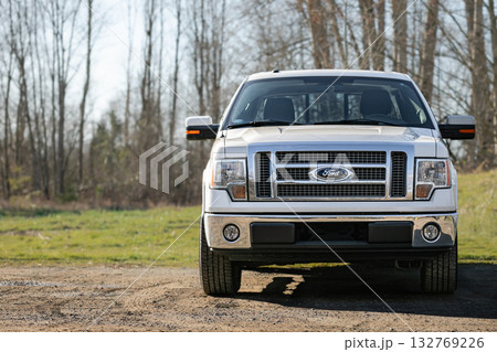 American silver Ford Pick up truck. Heavy duty vehicle parked outdoor in a park 132769226