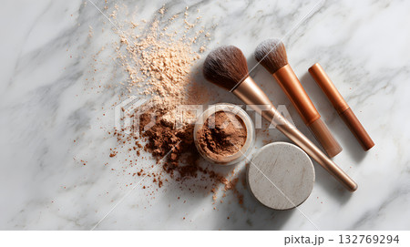 Makeup brushes and loose powder arranged on marble surface with beauty products scattered 132769294