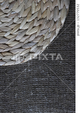 One placemat made of water hyacinth on rough linen burlap. 132770532