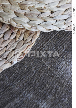 Two placemats made of water hyacinth on rough linen burlap. 132770536