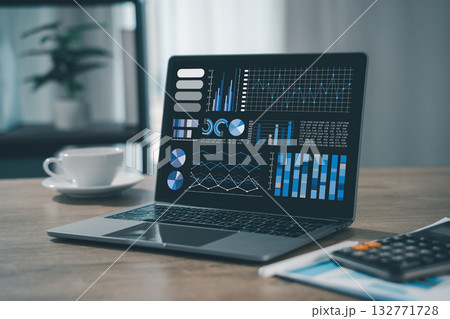 business analyst used a laptop to analyze financial statistics, creating a digital dashboard for marketing performance reports. 132771728