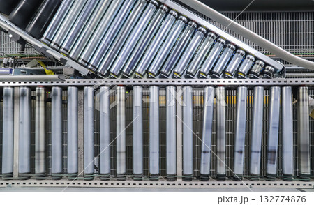 packing line in a logistics warehouse. conveyor belt in a modern production line packing line in a logistics warehouse. conveyor belt in a modern production line 132774876