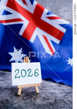 Australian flag and text 2026 trendy template for upcoming year campaigns. Patriotic design marking 2026 beside national flag. Concept of future vision and planning ideal for annual report or goal 132775065