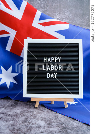 Australian flag and message board text HAPPY LABOR DAY festive holiday greetings. Concept of workers rights and public holiday, use in labor-themed marketing Australian flag and message board text HAPPY LABOR DAY festive holiday greetings. Concept of workers rights and public holiday, use in labor-themed marketing 132775075