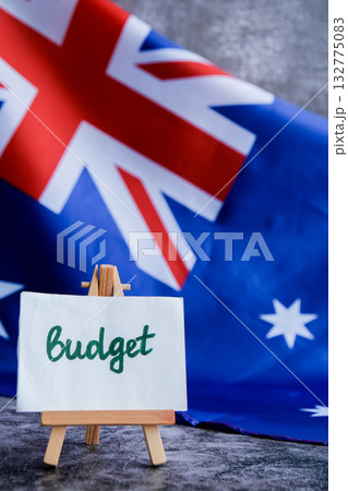 Australian flag background with text BUDGET for financial reports. Concept of fiscal planning and national funding ideal for economic or governmental Australian flag background with text BUDGET for financial reports. Concept of fiscal planning and national funding ideal for economic or governmental 132775083