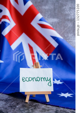 Australian flag with message text ECONOMY for finance or analysis. National theme and economic. Concept of fiscal trends and national growth use for reports 132775100