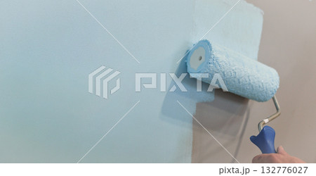 Roller Brush Painting, Worker painting on surface wall Painting apartment, renovating with white color paint. Leave empty copy space to write descriptive text beside. 132776027