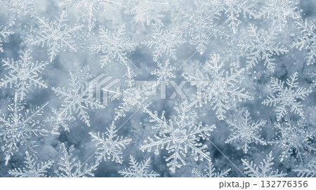 Beautiful frozen snowflakes close-up on icy winter background for seasonal and festive design 132776356