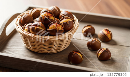 Wicker Basket with Roasted Chestnuts on Tray Wicker Basket with Roasted Chestnuts on Tray 132779393