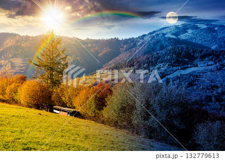 autumn equinox in mountain landscape. day and night time change concept. beautiful view of trees in fall foliage on the hillside with sun and moon at twilight. alps of countryside under dramatic sky 132779613