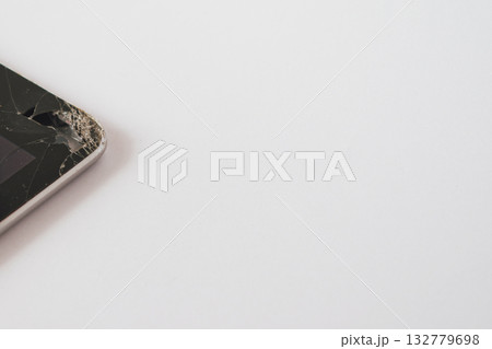 Close-up of a broken tablet display with cracks and visible damage to the device's interior 132779698