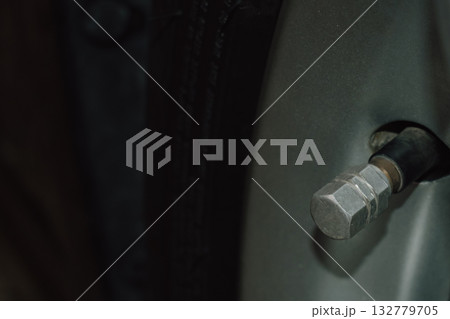 Close-up of a car tire valve stem nipple used for air pressure inflation 132779705