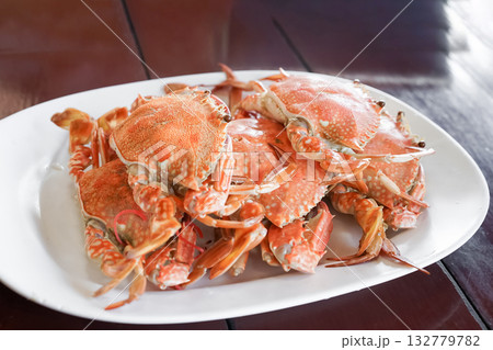 Fresh sea crabs cooked by charcoal grilling, served on the dish with Thai seafood dipping sauce at the famous local restaurant in Thailand. Fresh sea crabs cooked by charcoal grilling, served on the dish with Thai seafood dipping sauce at the famous local restaurant in Thailand. 132779782