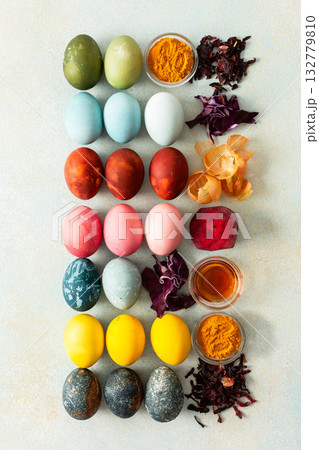 Brightly colored Easter eggs , showcasing various hues created from natural dye sources. Fresh ingredients are displayed alongside such as beets, turmeric and hibiscus, cabbage and onion peel, vinegar Brightly colored Easter eggs , showcasing various hues created from natural dye sources. Fresh ingredients are displayed alongside such as beets, turmeric and hibiscus, cabbage and onion peel, vinegar 132779810