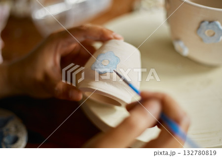 Close up hand of woman painting her pottery ceramic 132780819