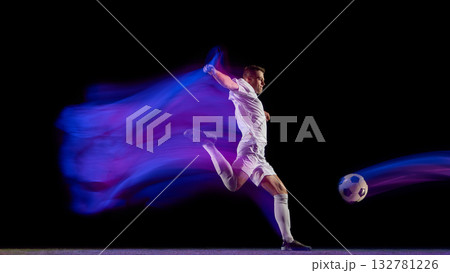 Soccer player kicking ball with dynamic blue and purple motion trail Soccer player kicking ball with dynamic blue and purple motion trail 132781226