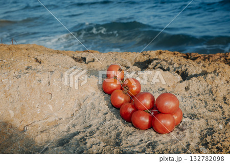 cluster of Spanish tomatoes on seaside rocks 132782098