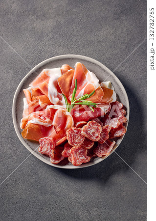 plate of prosciutto  on grey table background 132782785