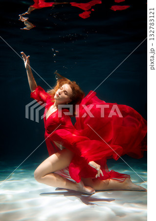 Underwater ballet grace, Swimmer in flowing crimson dress 132783121