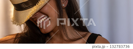 Young latina woman smiling happy wearing straw hat 132783736