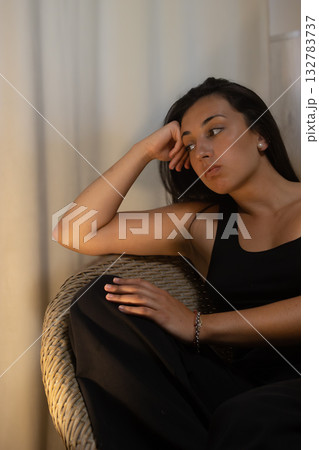 Young hispanic woman thinking at home feeling lonely. Vertical real shot. Young hispanic woman thinking at home feeling lonely. Vertical real shot. 132783737