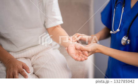 Asian nurse checks older patient pulse medical examination home care senior health assistance wellness checkup professional nursing service Asian nurse checks older patient pulse medical examination home care senior health assistance wellness checkup professional nursing service 132785042