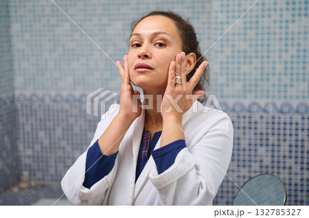 Woman Applies Facial Skincare Ritual In Bathroom Mirror, Embracing Self-Care And Wellness 132785327