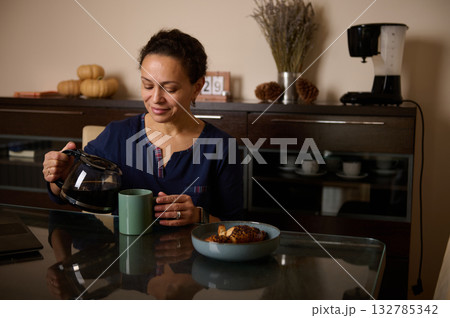Woman Pouring Coffee For Breakfast In Cozy Home Kitchen Setting With Pastry Morning Mug 132785342