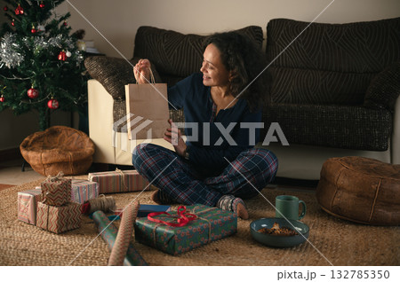 Cozy Holiday Gift Exchange At Home With Woman Enjoying Christmas Moments 132785350