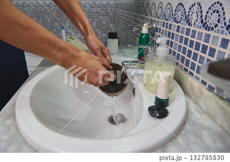 Hands Washing Ceramic Cup Under Running Water At Bathroom Sink With Soap Dispenser Hands Washing Ceramic Cup Under Running Water At Bathroom Sink With Soap Dispenser 132785830