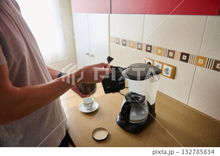 Morning Coffee: Person Pouring From Drip Coffee Maker Into Small Cup In Kitchen Morning Coffee: Person Pouring From Drip Coffee Maker Into Small Cup In Kitchen 132785834