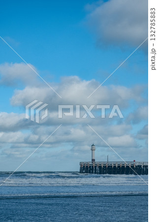 seaside lighthouse guides turbulent waters, ocean sentinel standing tall against lively waves 132785883