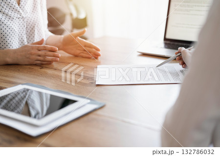 Business people discussing contract signing deal while sitting at the wooden table in office. Partners or lawyers working together at meeting. Teamwork, partnership, success concept Business people discussing contract signing deal while sitting at the wooden table in office. Partners or lawyers working together at meeting. Teamwork, partnership, success concept 132786032