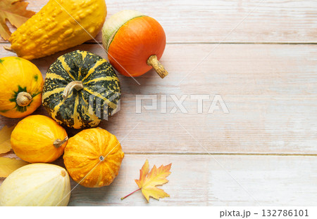 Autumn harvest gourds and pumpkins on wood background 132786101