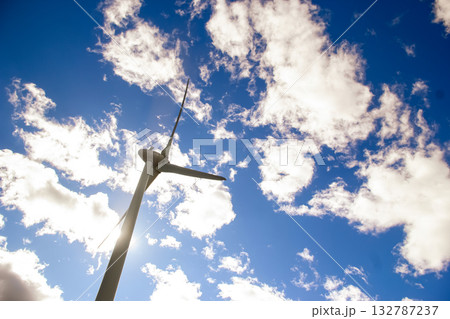 Windmill with huge blades in the sky, sustainable energy source 132787237