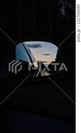 Vertical. Sunset rearview road. Driving a car on a highway at dusk. 132788099