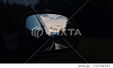 Sunset rearview road. Driving a car on a highway at dusk. Sunset rearview road. Driving a car on a highway at dusk. 132788101