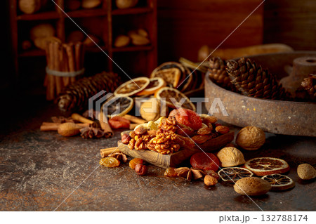 Dried fruits and nuts on a brown vintage background. 132788174