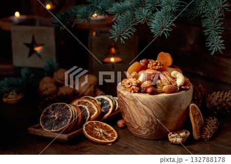 Dried fruits and assorted nuts on an old wooden table. 132788178