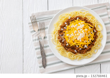 Cincinnati chili with spaghetti on white plate 132788461