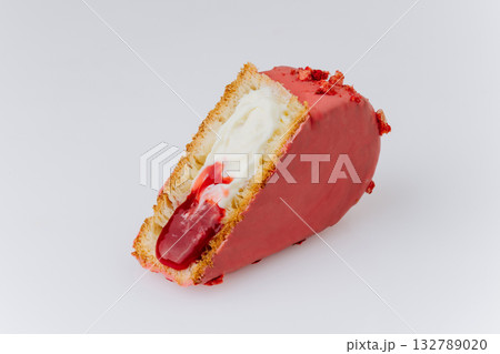 Heart-shaped croissant with red glaze, cream filling and berry jam on white background Heart-shaped croissant with red glaze, cream filling and berry jam on white background 132789020