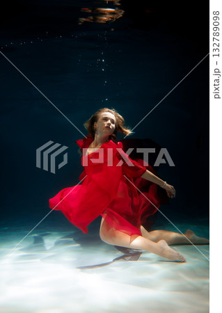 Minimalist underwater art featuring red cloth and contrasting Minimalist underwater art featuring red cloth and contrasting 132789098